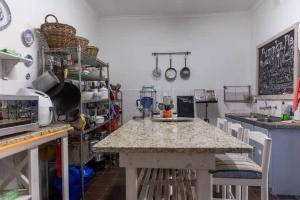 a kitchen with a counter and a table with chairs at Langebaan 4 Bedroom Holiday Home in Langebaan