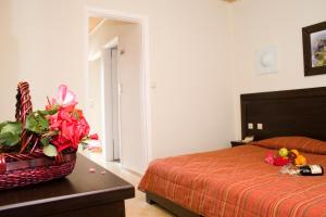 a bedroom with a bed and a basket of fruit on a table at Paradise Apartments in Laganas