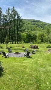 a park with benches and a fire pit in the grass at Majestic Mountain Retreat with Fire Pit Facing Mtn in Hunter