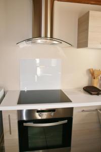 a kitchen with a stove with a hood over it at Apartment Au Calme in Munster