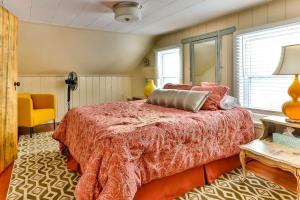 a bedroom with a large bed and a yellow chair at Majestic Mountain Retreat with Fire Pit Facing Mtn in Hunter