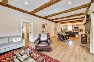 a living room with a couch and a table at Mountain Cabin with Scenic Views and Hot Tub in Windham +11 photos