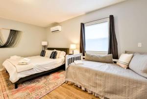 a bedroom with a bed and a couch and a window at Mountain Cabin with Scenic Views and Hot Tub in Windham