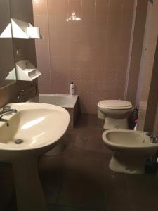 a bathroom with a white sink and a toilet at Viale Ancona by Ospitaci in Foligno