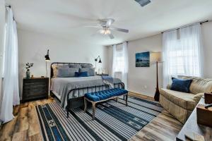 a bedroom with a bed and a couch at Peach Street Retreat - Fire Pit and Close to Main St in Fredericksburg