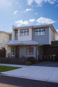 a large white house with a fence at Luxe Altona Haven - Executive 3BR Family Townhouse in Newport