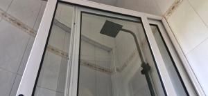 a glass door with a street light in a building at 5 Empologoma Cottage - Benanda Forest Resort in Masaka