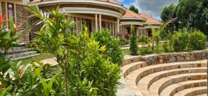 a house with a garden and stairs in front of it at 5 Empologoma Cottage - Benanda Forest Resort in Masaka