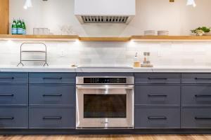 a kitchen with blue cabinets and an oven at Luxury Home with Vail Mountain View in Vail +60 photos
