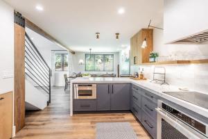 a kitchen with wooden floors and white walls at Luxury Home with Vail Mountain View in Vail
