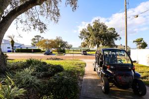 a small car parked on the side of a street at FunTropicalTinyHomeGolfCartLake in Orlando +40 photos