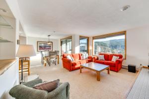 a living room with red couches and a table at 2 Mi to Winter Park Resort: Condo w/ Pool Access! in Winter Park