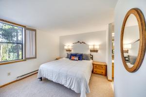 a bedroom with a bed and a mirror at 2 Mi to Winter Park Resort: Condo w/ Pool Access! in Winter Park +18 photos
