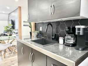 a kitchen with a sink and a counter top at Wolfe Chutes-Montmorency in Boischâtel +51 photos