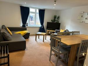 a living room with a couch and a table at The Coach House in Salisbury