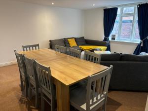 a living room with a wooden table and a couch at The Coach House in Salisbury