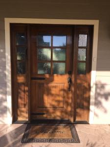 a wooden front door of a house with windows at Hailey's Cottage on Small Farm-16 minutes to Silos in Bellmead +46 photos
