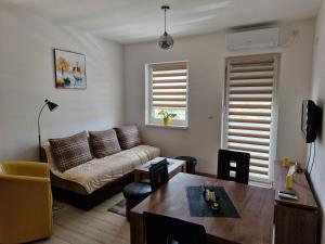 a living room with a couch and a table at Apartman Curcic 1 in Soko Banja