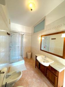 a bathroom with a sink and a shower and a mirror at Armando's House in Pontone +4 photos