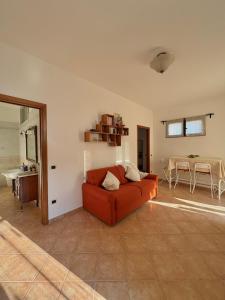 a living room with a red couch and a table at Armando's House in Pontone