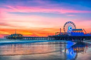 a pier with a ferris wheel on the beach at sunset at Beautiful Getaway Near Venice in Los Angeles