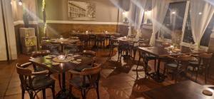 a restaurant with tables and chairs in a room at Hotel Stadt Coblenz in Fachbach