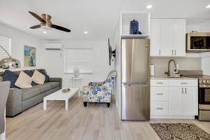 a kitchen and living room with a stainless steel refrigerator at ULTRA spacious apartment steps from the beach in Hollywood