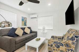 a living room with a couch and a chair at ULTRA spacious apartment steps from the beach in Hollywood +7 photos