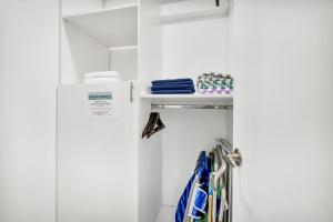 a closet with white walls and a white refrigerator at ULTRA spacious apartment steps from the beach in Hollywood