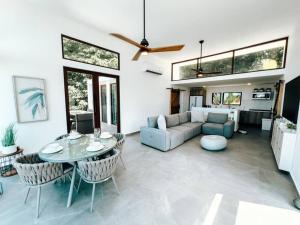 a living room with a table and a couch at Yunque Reserve Secluded Rainforest House in Hato Candal