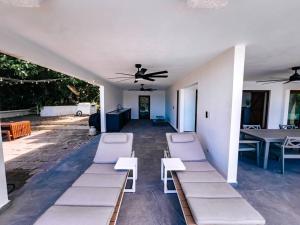 a room with lounge chairs and a ceiling fan at Yunque Reserve Secluded Rainforest House in Hato Candal