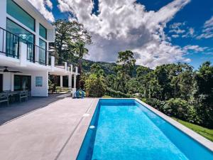 a swimming pool in the backyard of a house at Yunque Reserve Secluded Rainforest House in Hato Candal