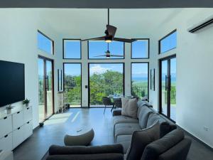a living room with a couch and a tv at Yunque Reserve Secluded Rainforest House in Hato Candal
