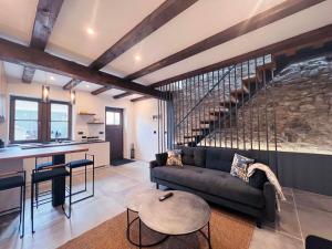 a living room with a couch and a kitchen at Rural Family Escape in Vipava
