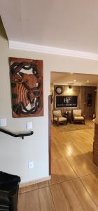 a living room with a large painting on the wall at Hotel Barretos in Barretos
