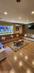 a living room with a couch and a coffee table at Hotel Barretos in Barretos