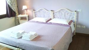 Postel nebo postele na pokoji v ubytování B&B "Corte San Tomaso"