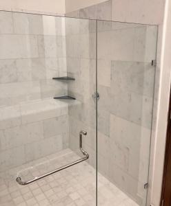 a shower with a glass door and a tile floor at Casa Cielo Vallarta V-Golf in Puerto Vallarta