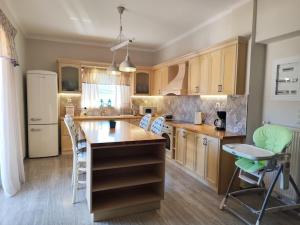 a kitchen with a island and chairs in it at Thermian Country House in Thermo
