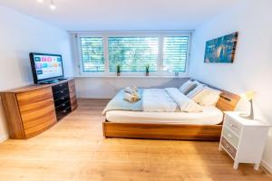 a bedroom with a bed with a teddy bear on it at Nachhaltig Wohnen im 1, Stock, gratis Parkplatz! in St. Gallen