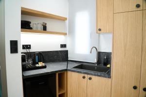 a kitchen with a sink and a counter top at 42 Studio 16 in Komotini