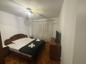 a bedroom with a bed with two candles on it at Apartament City Center Craiova in Craiova +26 photos