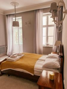 a bedroom with a large bed and a window at Old Town Heart XVIII - Downtown Luxury in Warsaw