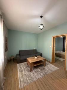 a living room with a couch and a table at Christina Apartment in Drama