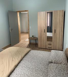 a bedroom with a bed and a wooden cabinet at Christina Apartment in Drama