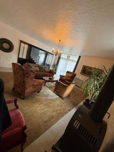 a living room with a couch and a table at 13 Rue du Perré Maison de vacances in La Membrolle-sur-Choisille
