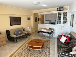 a living room with a couch and a table at Endless Blue in Loutraki