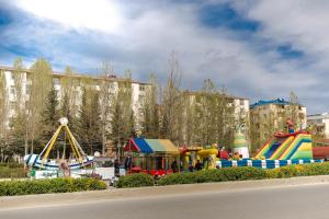 a playground in a park with slides and rides at GreenHouse in Masazır