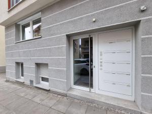 a building with two garage doors and a car at Stuttgart City Apartment B in Stuttgart
