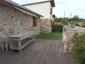a wooden bench sitting on a patio next to a building at Fisker in Mar del Plata